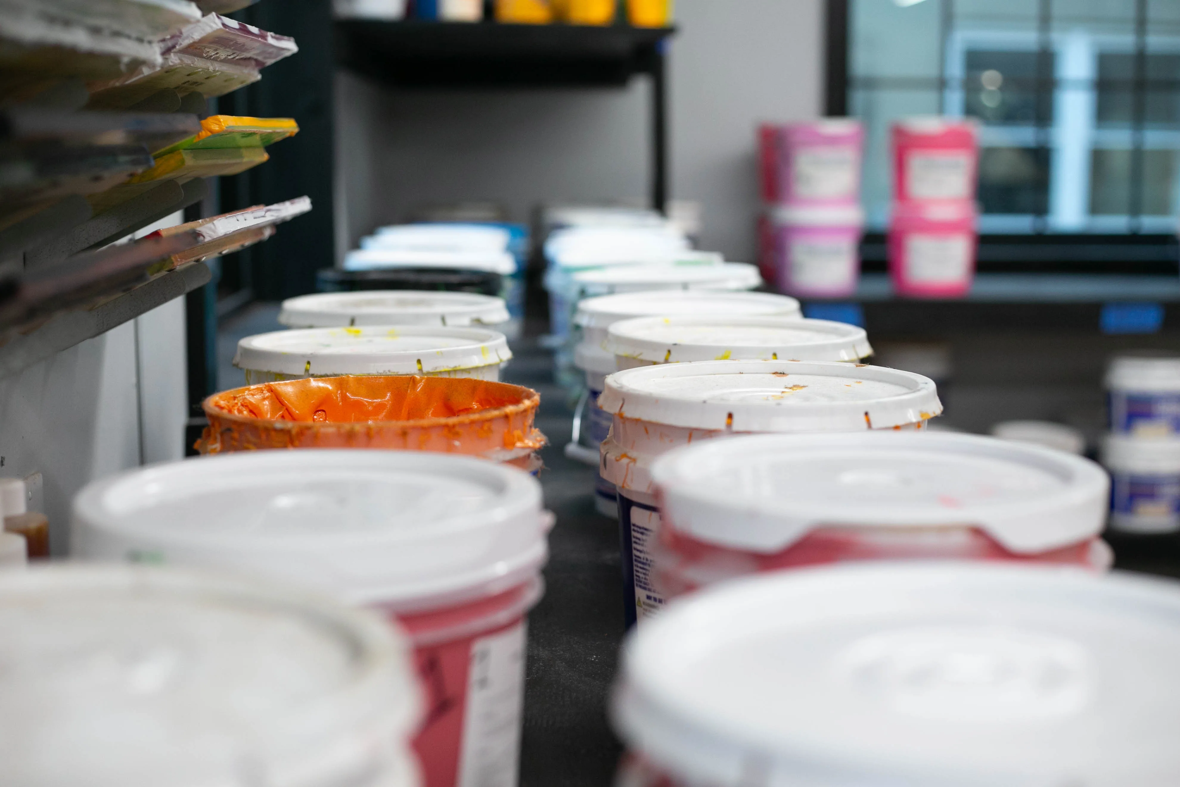 Plastisol ink tubs organized by color